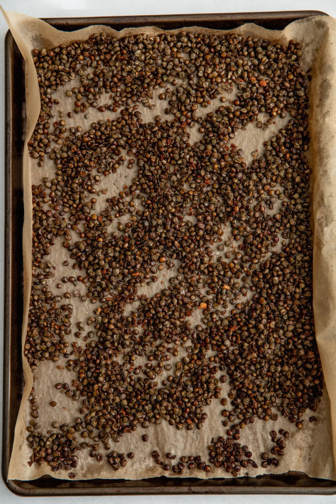 Roasted crispy lentils on a baking tray.