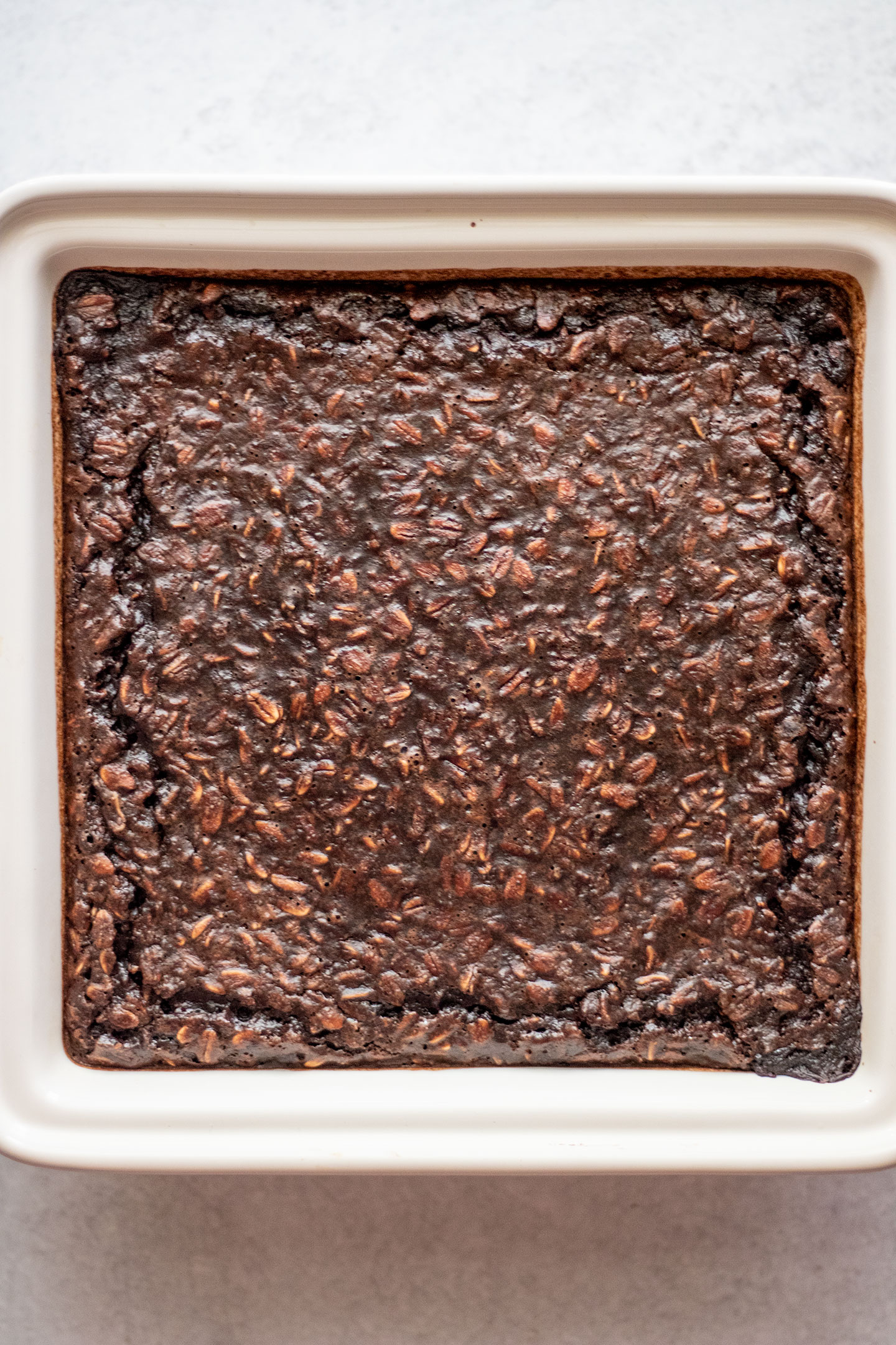 The fudgy baked oats in the baking tray after baking in the oven.