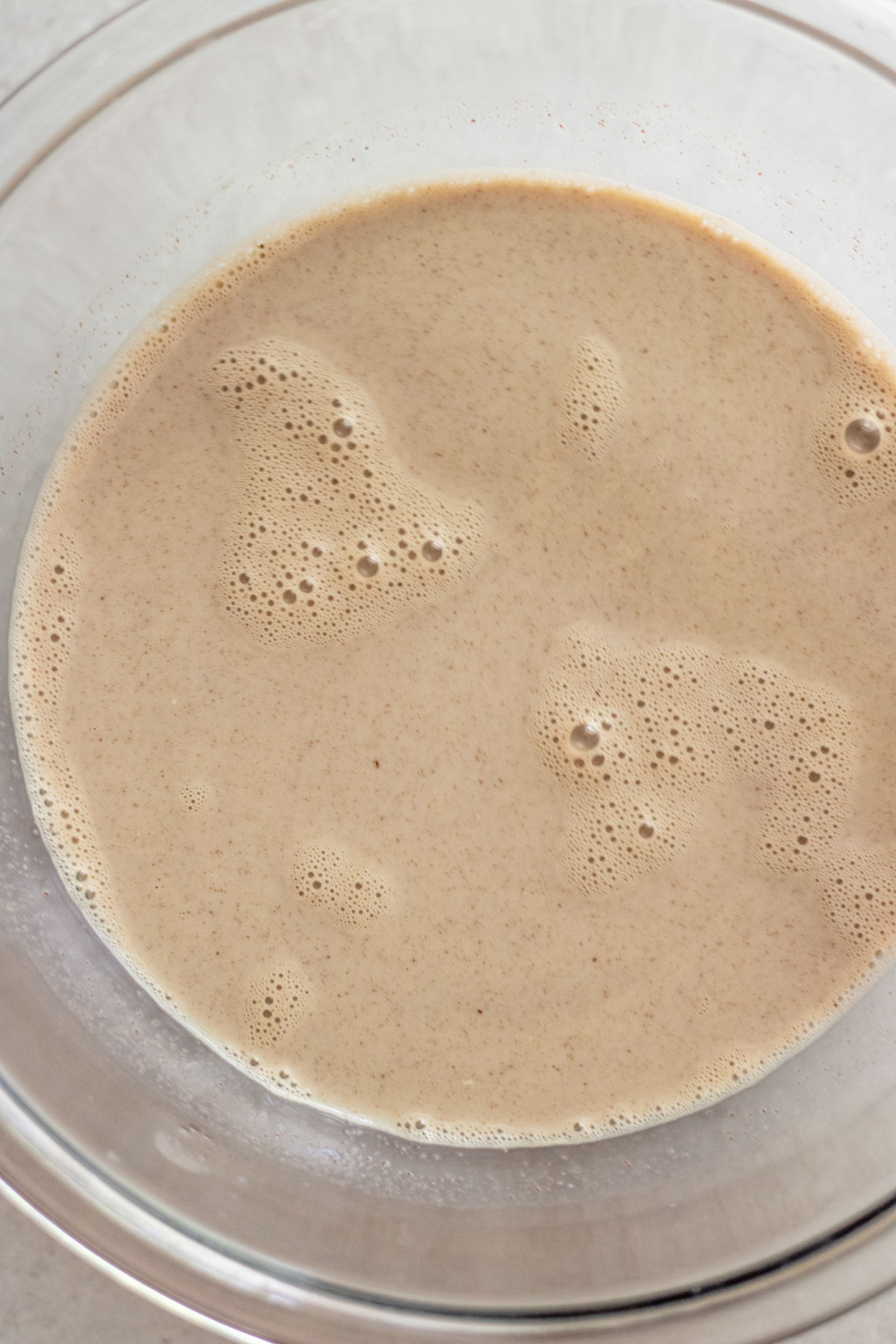 Whisking chocolate chips into warm soy milk.