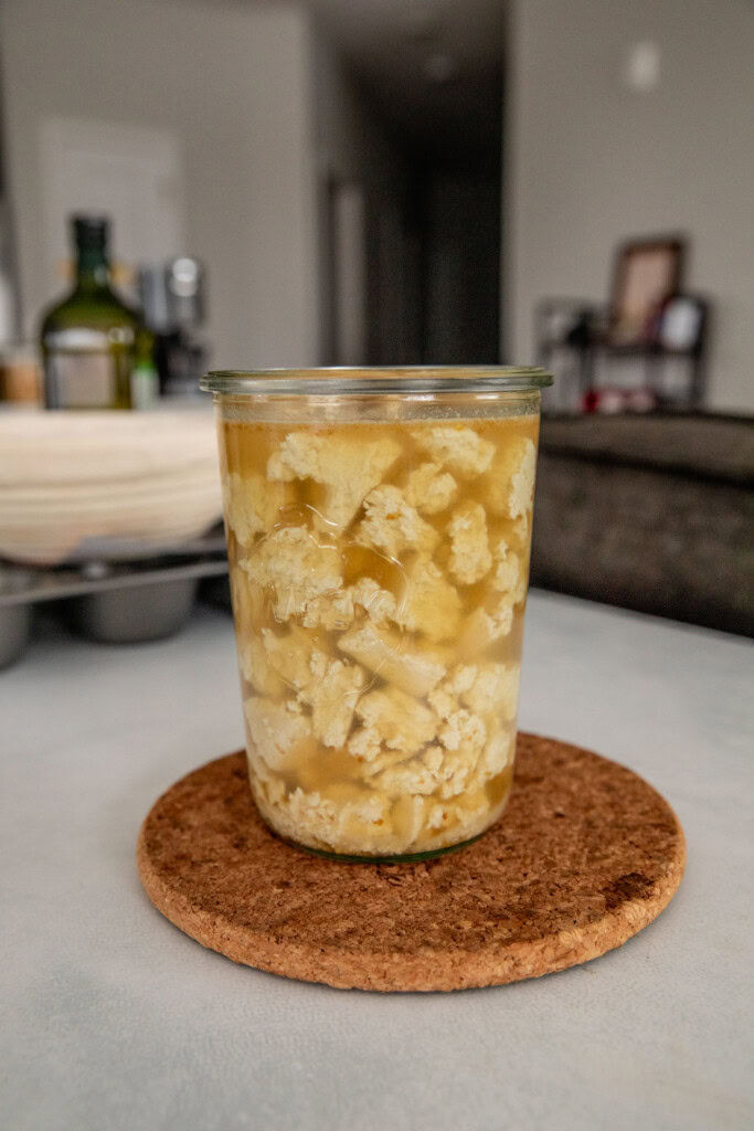 Soaking torn tofu pieces in vegetable broth.