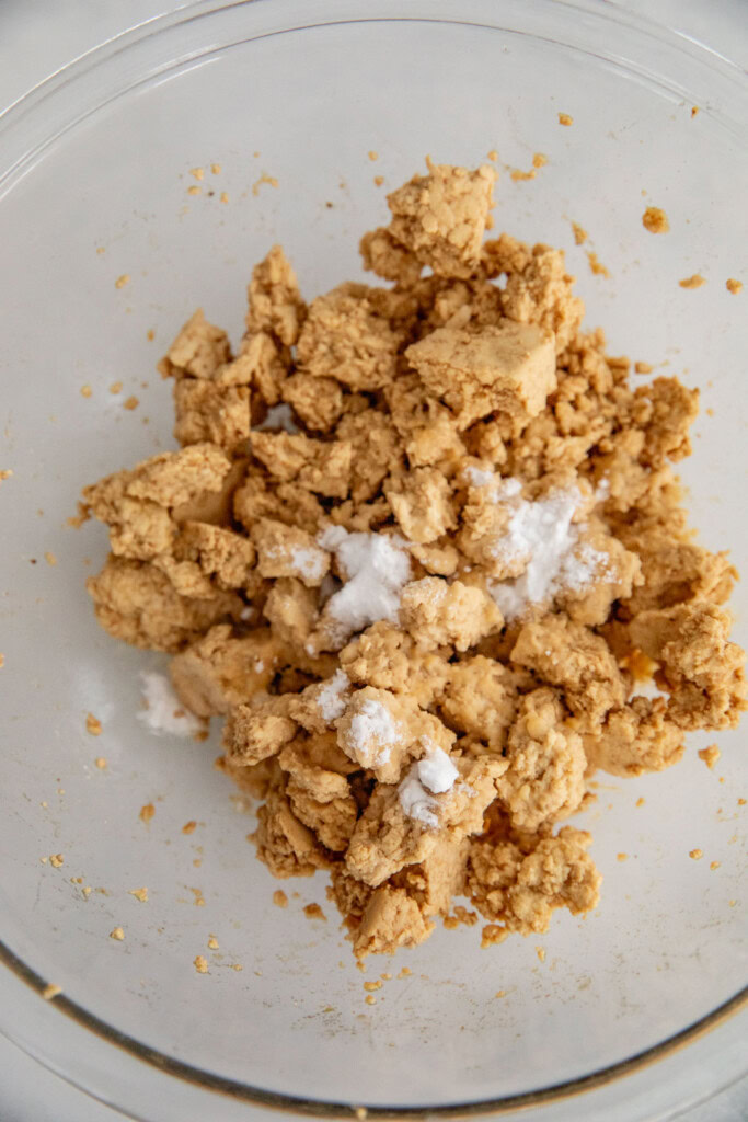 Bowl of seasoned tofu topped with cornstarch and oil.