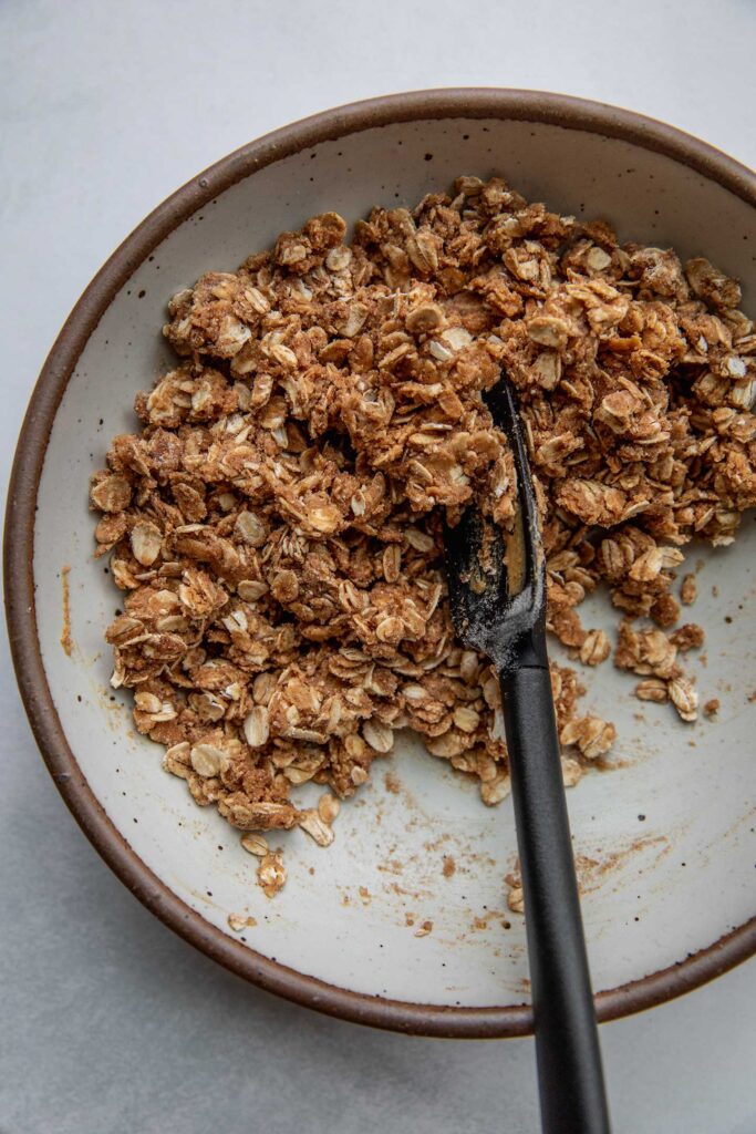 Mixing the crumble in a bowl.