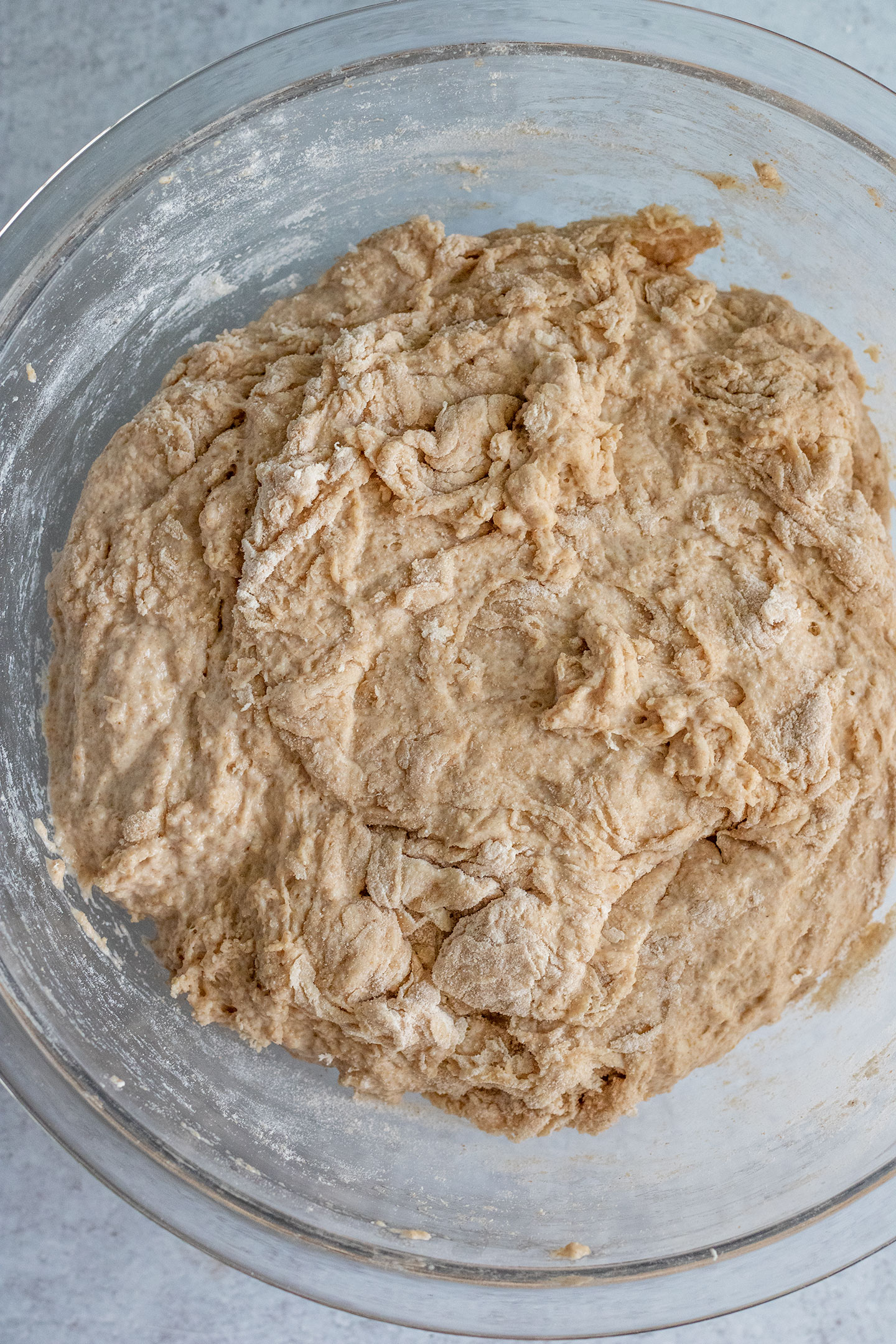Mixing the flour and wet ingredients to form a rough dough.