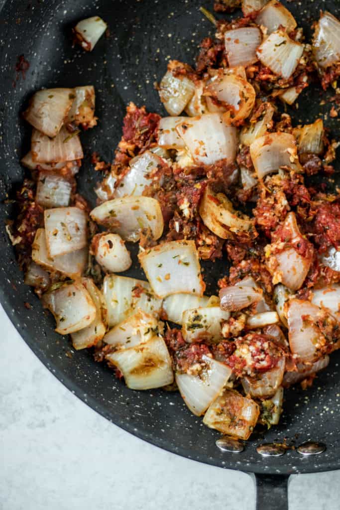 Sauted onions and tomato paste in a pan.