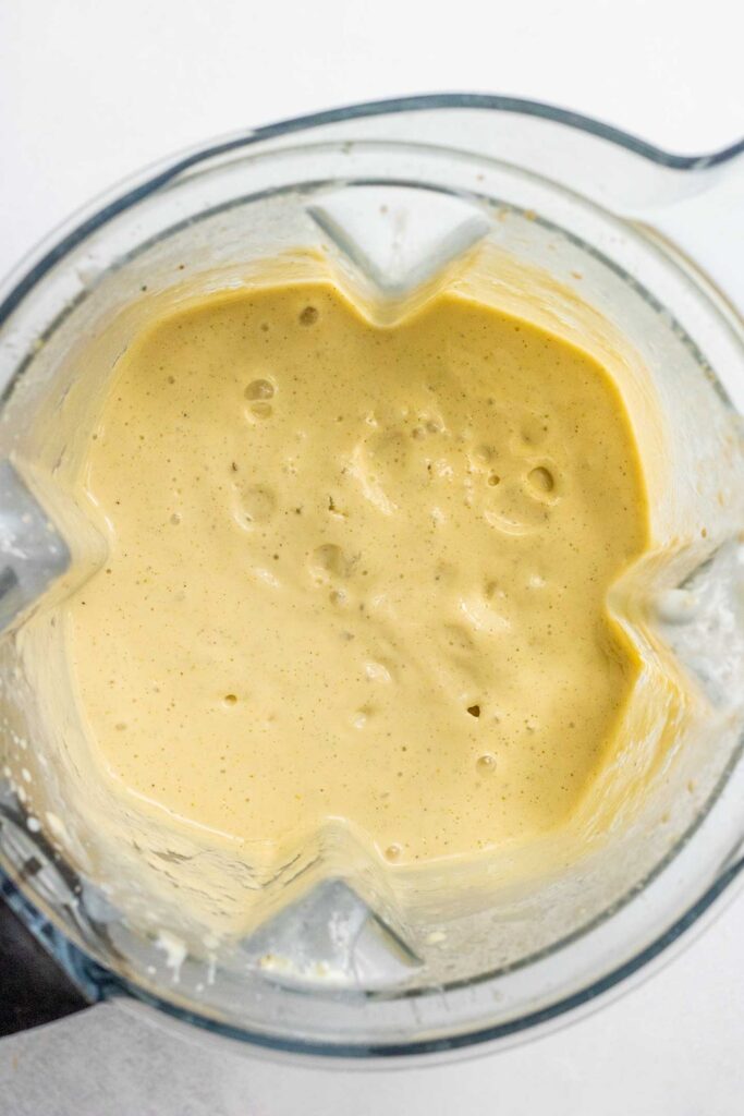 Fully blended mango milk in a blender cup.
