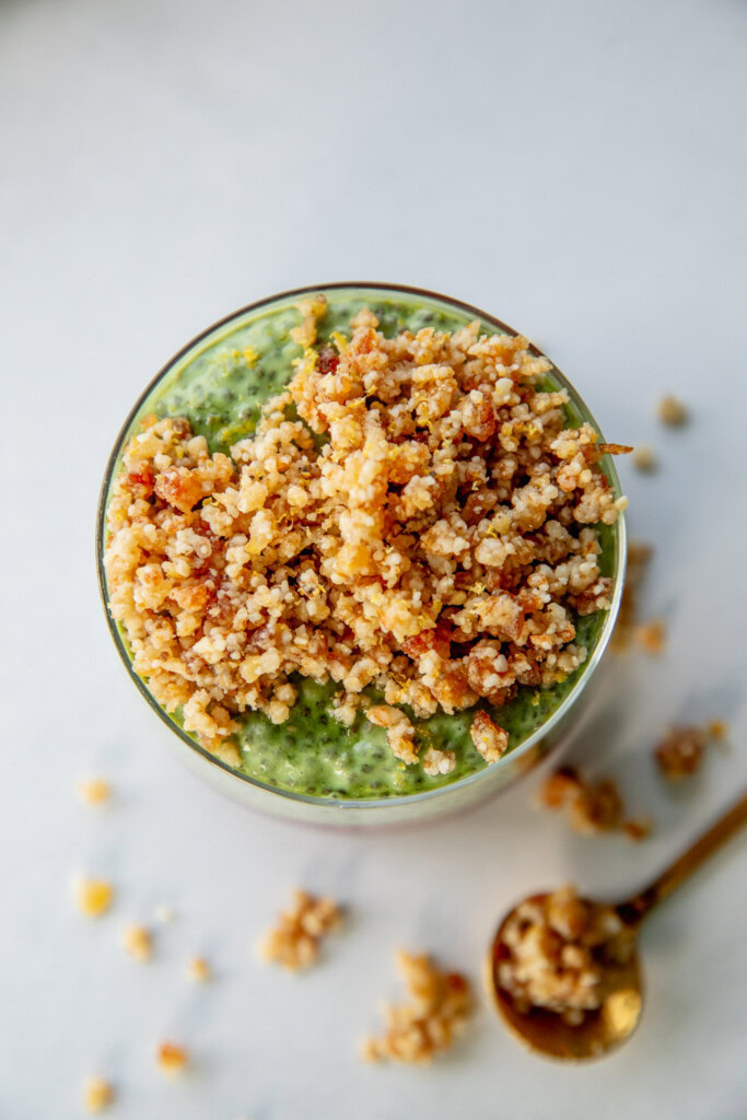 Top view of a jar of matcha pudding topped with pie crumble topping.