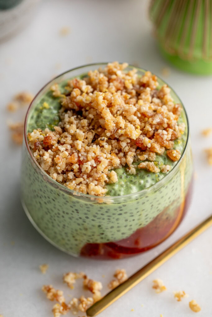 Cup filled with a dollop of strawberry jam, matcha pudding, and pie crust crumble.