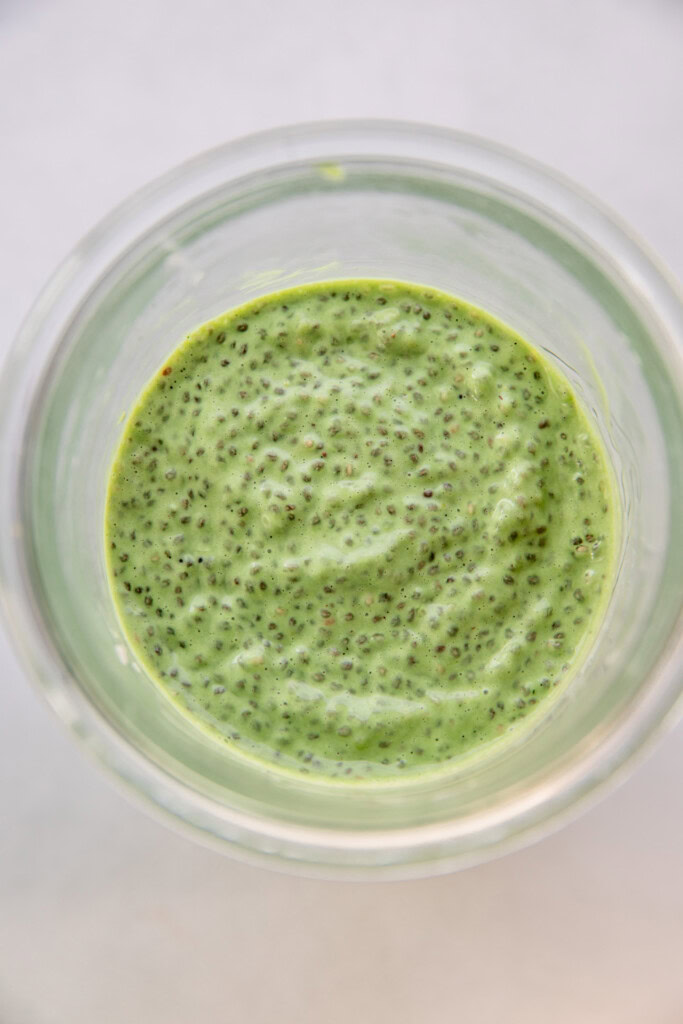 Storage jar with fully hydrated matcha chia pudding.