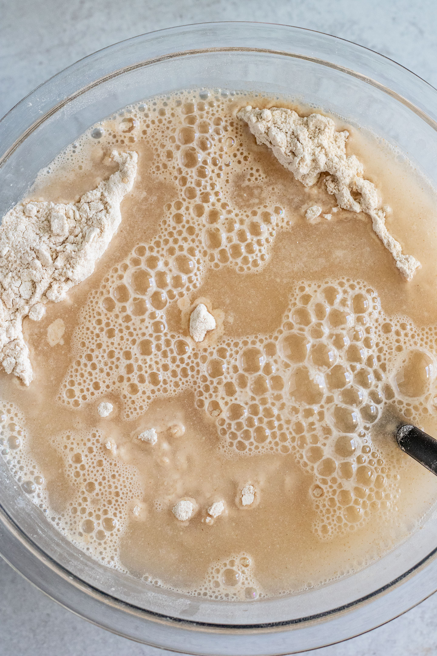 Mixing the flour with the water and yeast into a bowl.