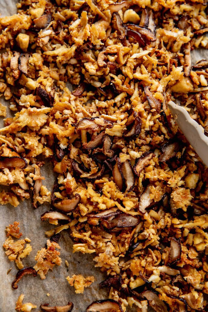 Roasted mushrooms and shallots tossed together in a pan.