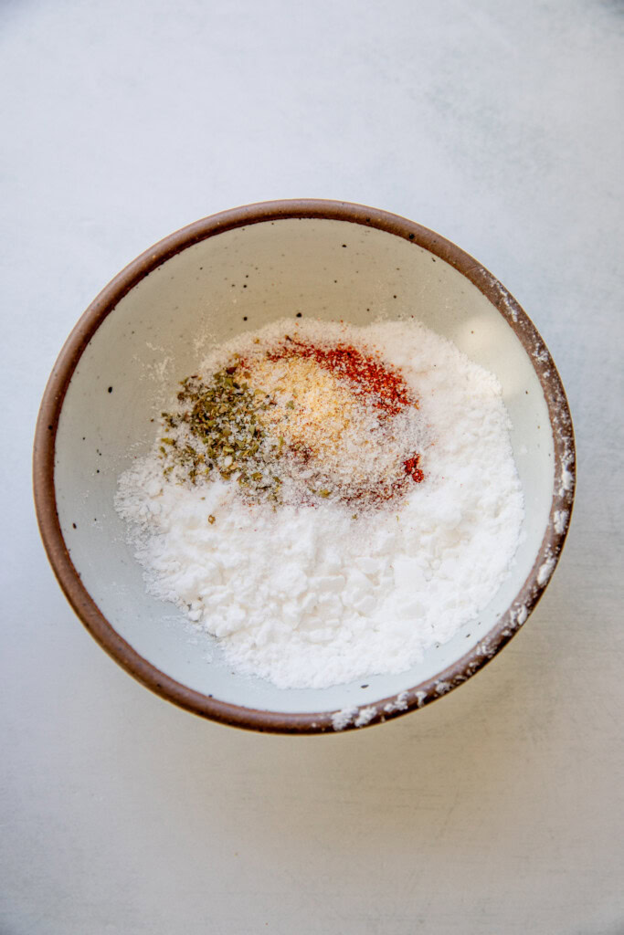 Bowl of potato starch combined with seasonings.