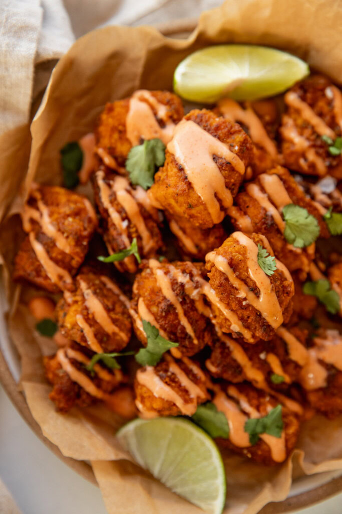 Plate of pica tofu topped with a drizzle of mayo ketchup over top and cilantro.