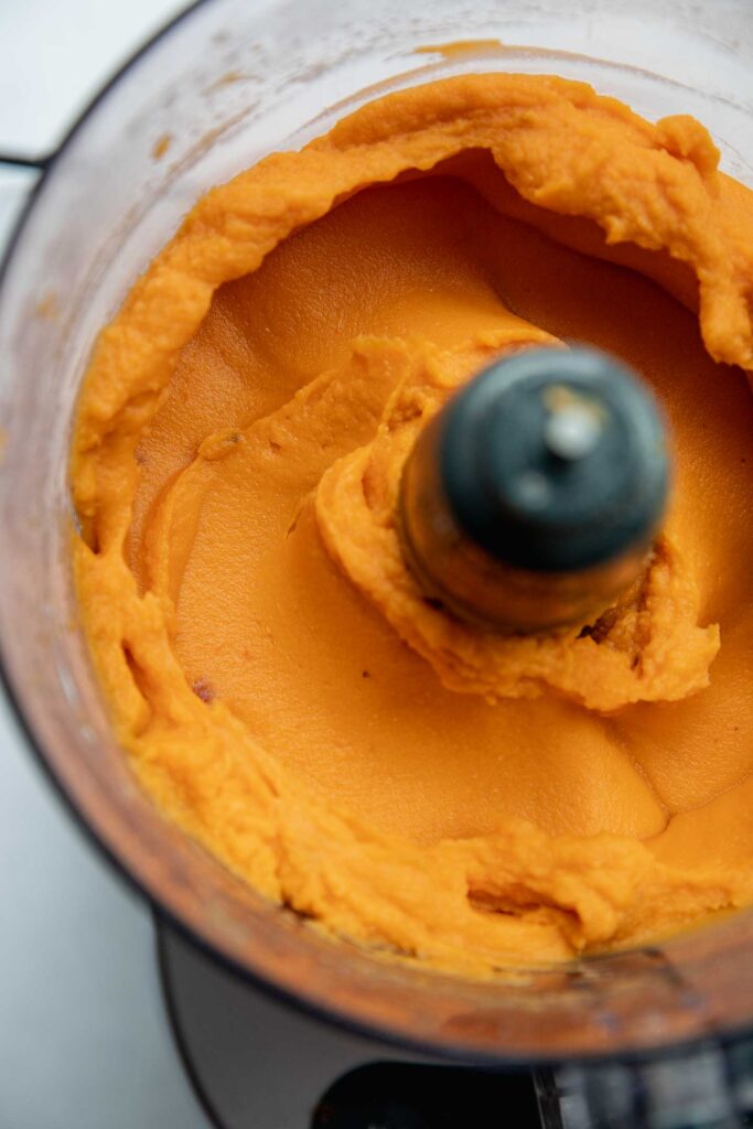 Blending sweet potato mash in a food processor.