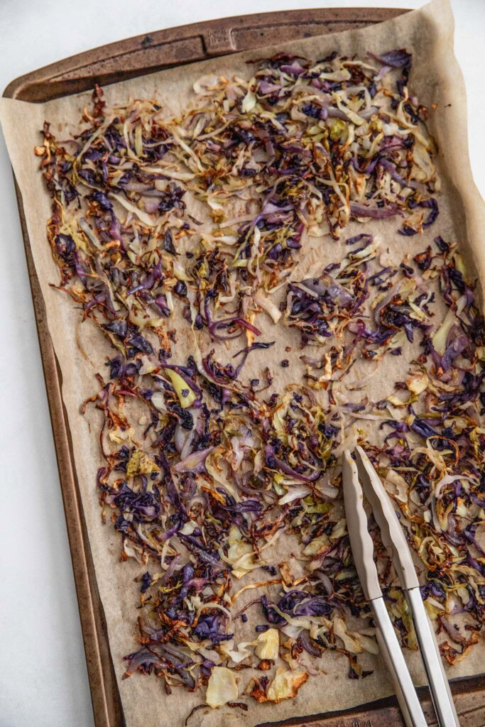 Roasted cabbage and onions on a pan.