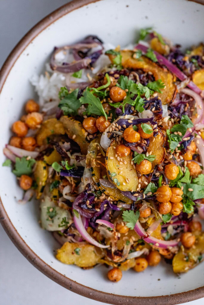 Roasted cabbage, squash, chickpeas and marinated onions topped over a bowl of rice.