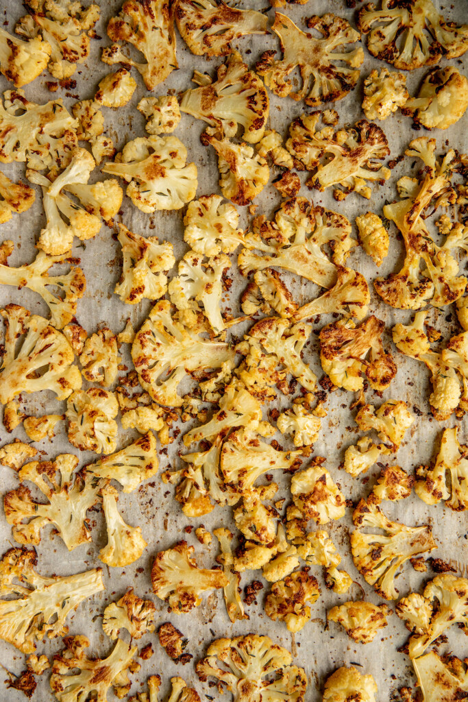 Roasted cauliflower on a baking tray.