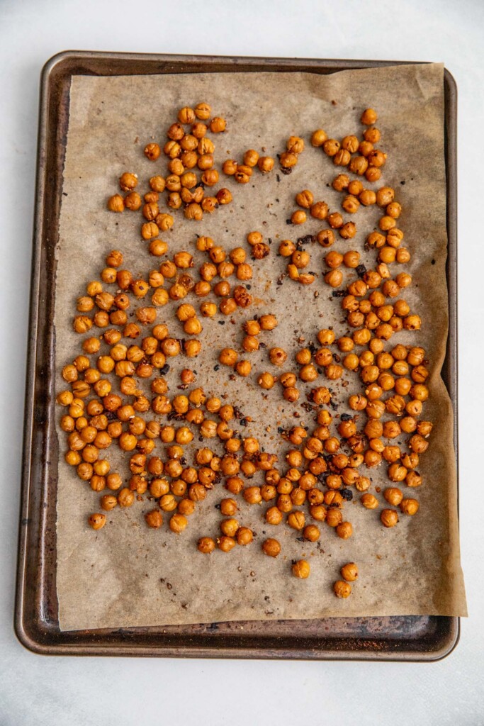 Roasted chickpeas on a baking tray.