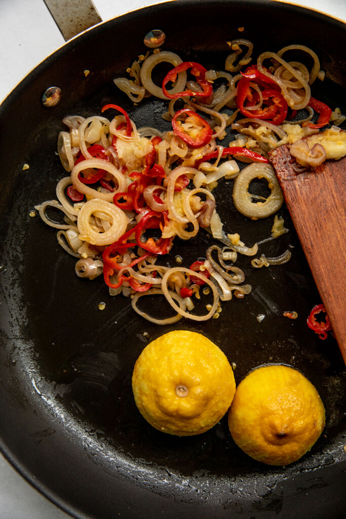 Searing lemon and sauteing shallots, pepper and garlic together in the same pan.