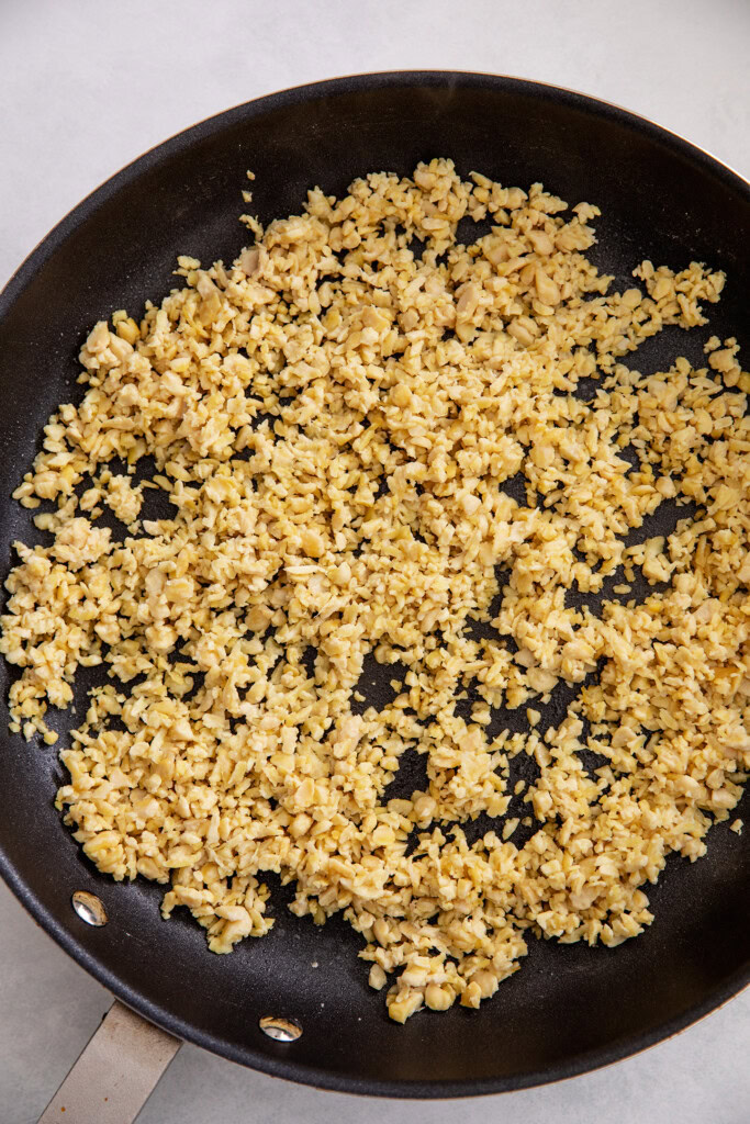 Shredded tempeh in a pan.