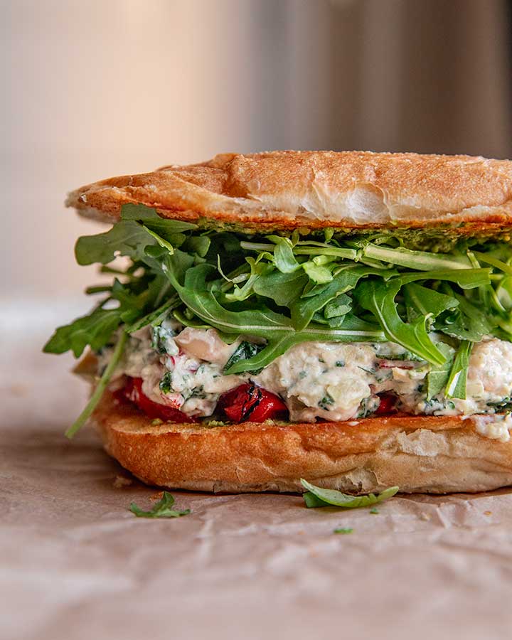 Sandwich stuffed with roasted red pepper, spinach artichoke white beans, arugula and pesto.