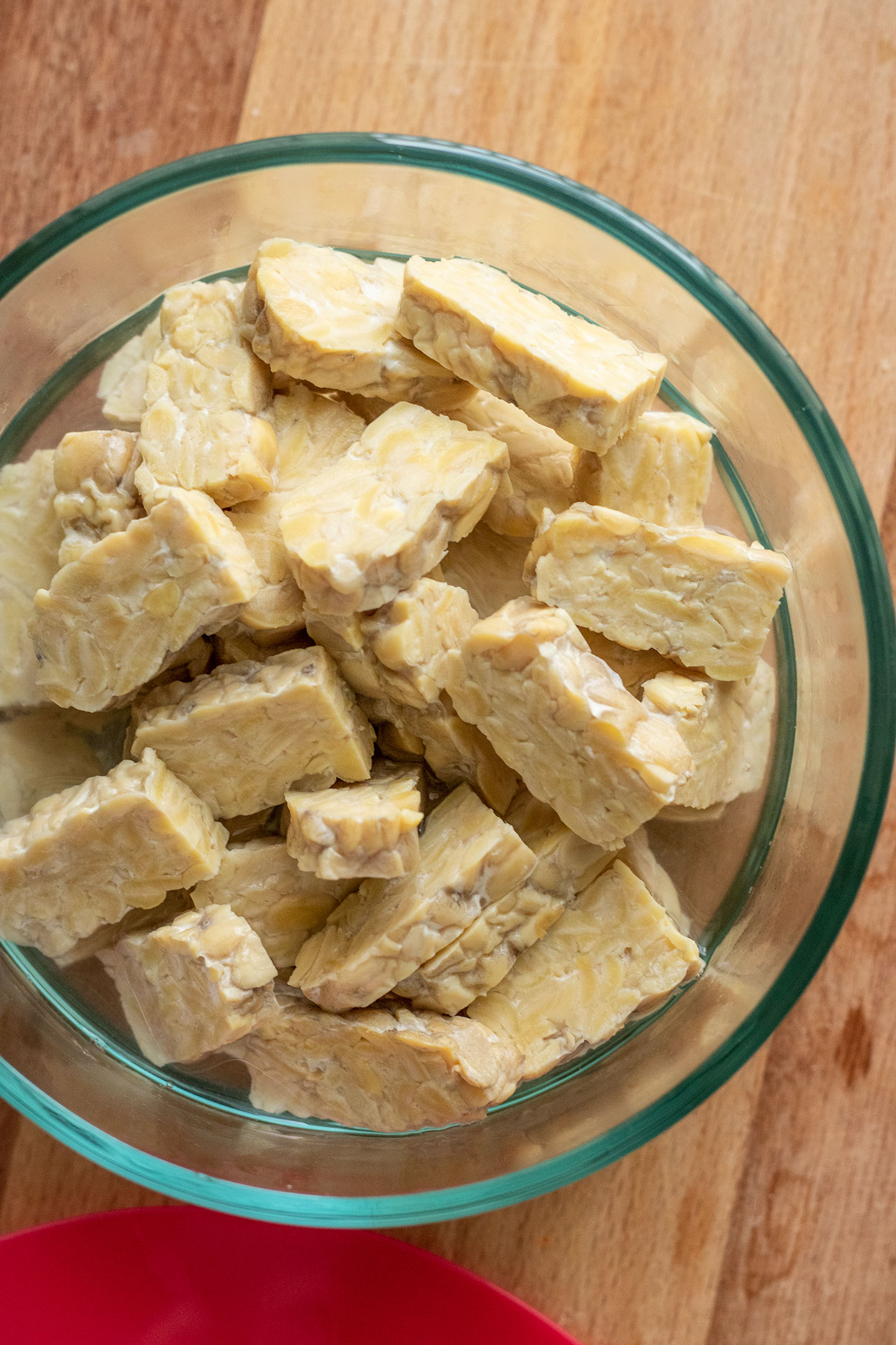 Tempeh in a bowl with boiling water to steam.