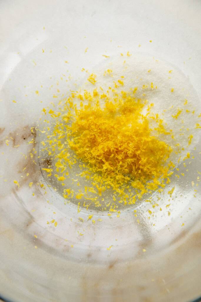 Lemon zest and sugar in a bowl.