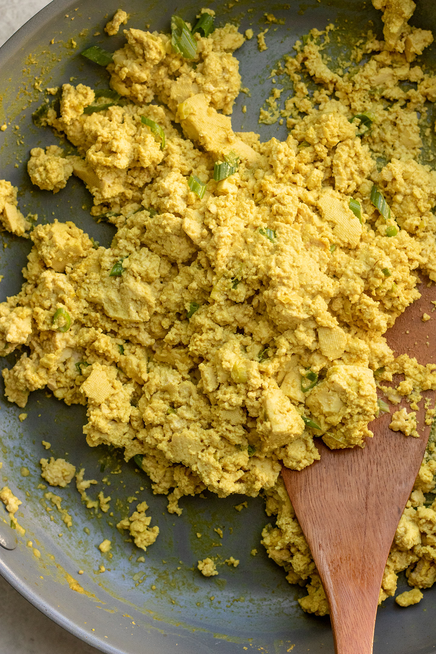 Tofu completely coated in seasonings including bright yellow turmeric.