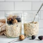 Jar of overnight oatmeal cookie dough with cookie dough bites in two jars with spoons.