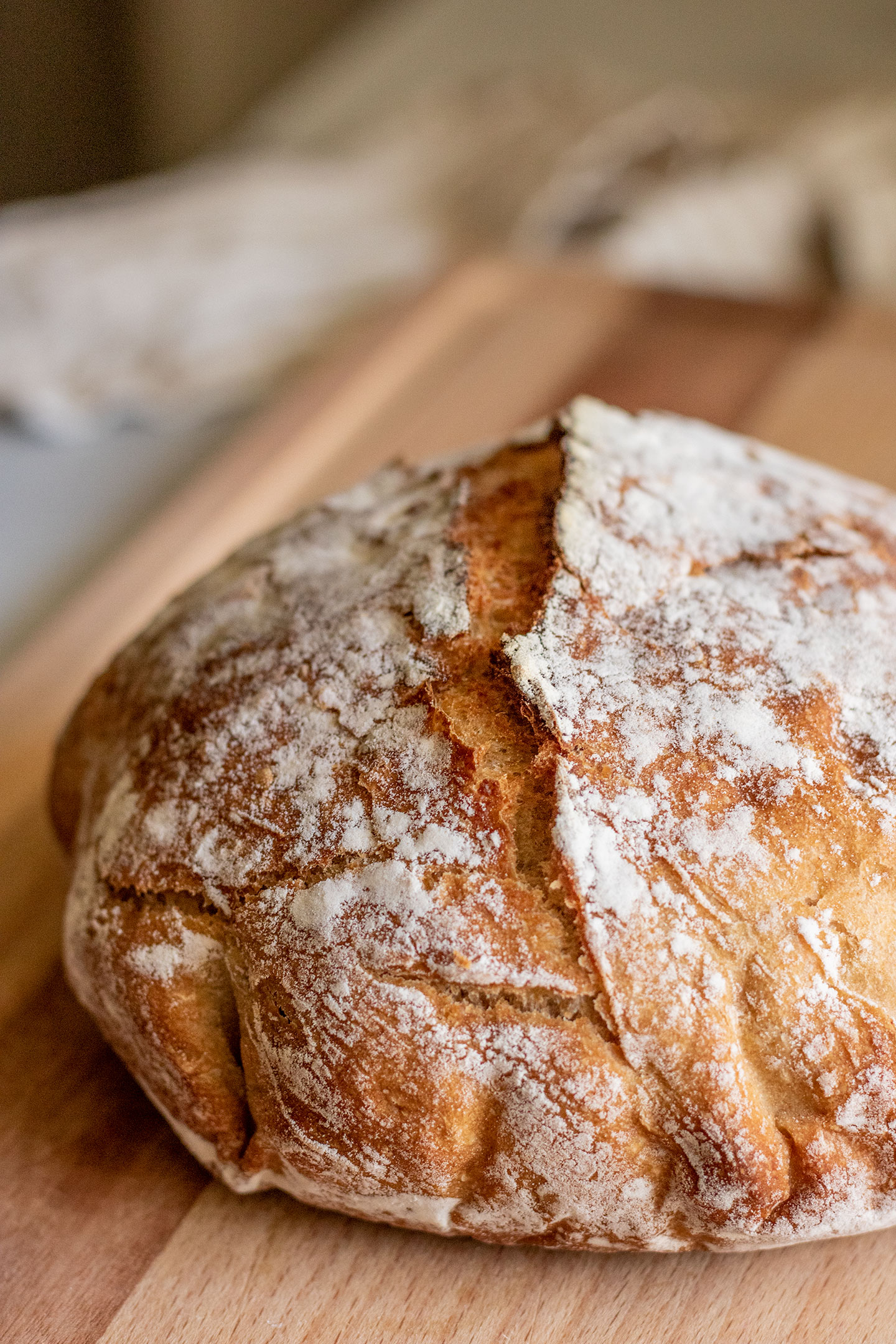 Fully cooked whole wheat bread placed on a cutting board after cooling.
